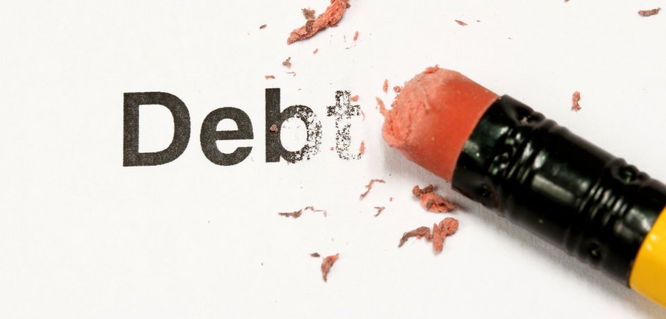 Broken words "Debt" erased with orange crayon, symbolising debt and financial issues.