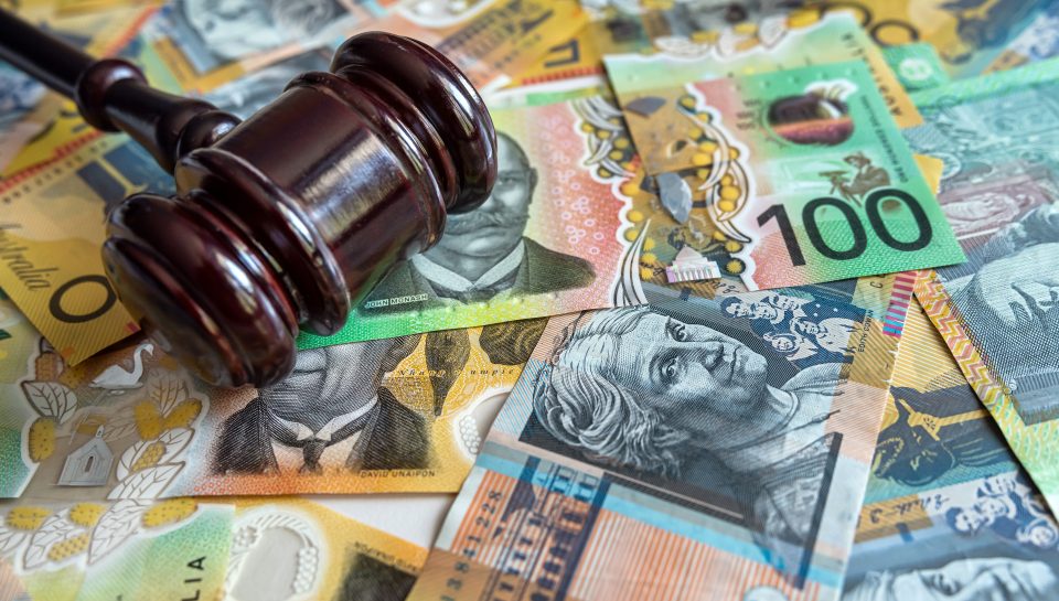 Gavel on Australian currency, symbolising legal financial disputes or debt.
