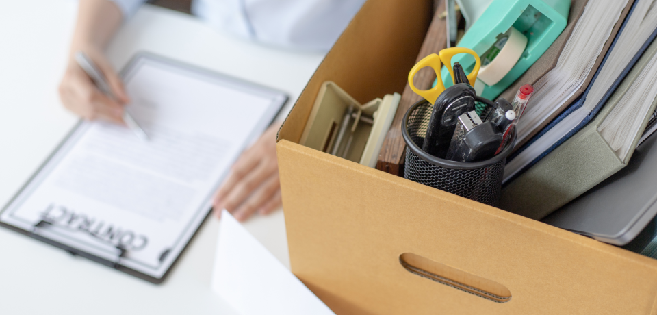 Office desk with legal documents, stationery, and a cardboard box, representing legal support in property, business, and civil law in Toowoomba.