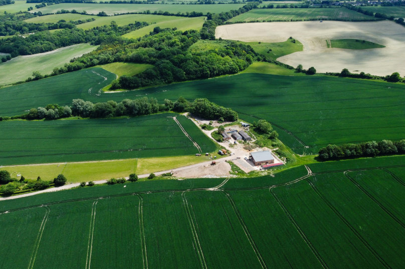 Lush green Queensland farmland with property, construction, and civil dispute legal services.