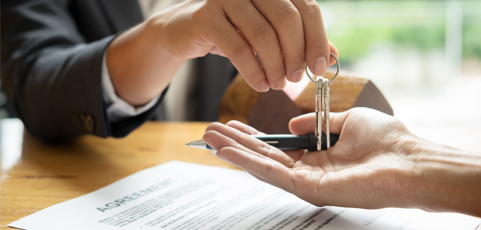 Keys handover for property transaction at Toowoomba law firm in Queensland.