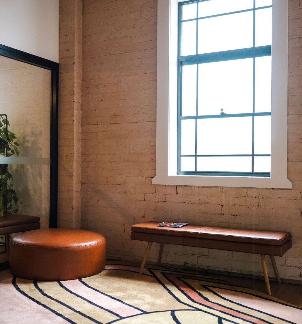 Modern office space interior with brick wall, large window and stylish decor in Toowoomba, Queensland.