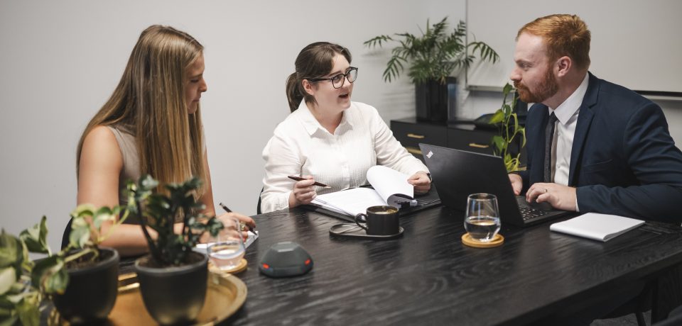 Business meeting discussing property and construction law in Toowoomba, Queensland.