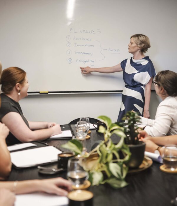 Professional women discussing legal strategies in a corporate meeting room in Toowoomba, Queensland.