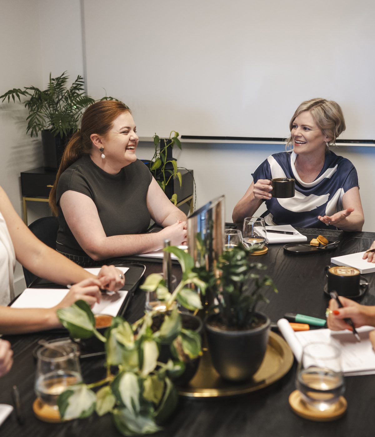 Professional women meeting in a modern conference room for business discussion, illustrating legal expertise.