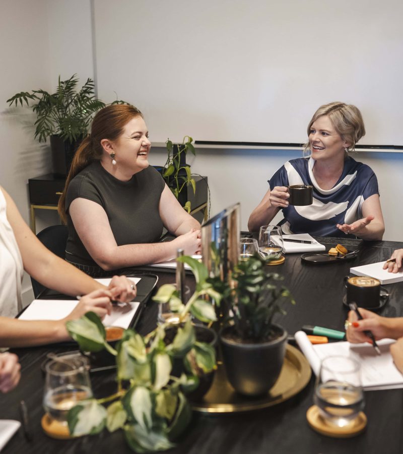 Professional women meeting in a modern conference room for business discussion, illustrating legal expertise.