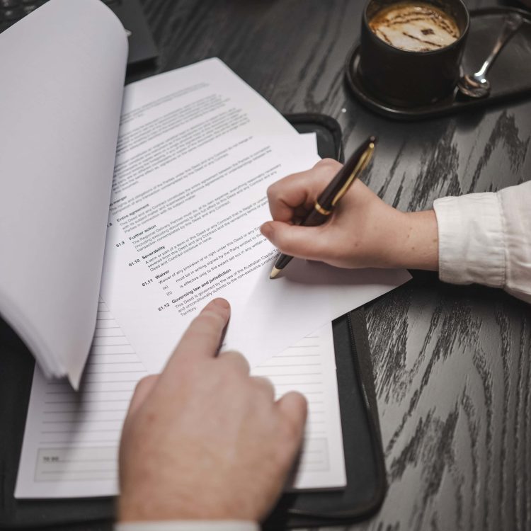 Legal document signing at law firm in Toowoomba for property, business, civil dispute, construction law.