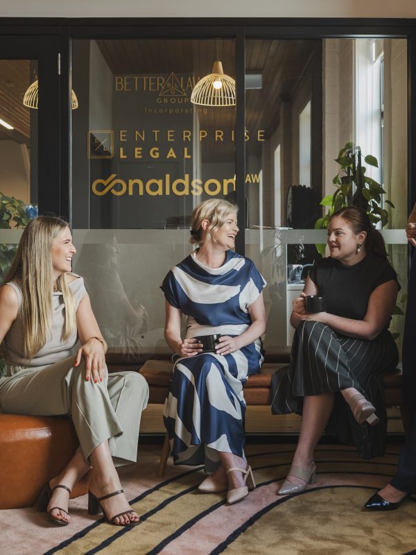Women colleagues having a casual discussion in an office lounge, law firm in Toowoomba Queensland.