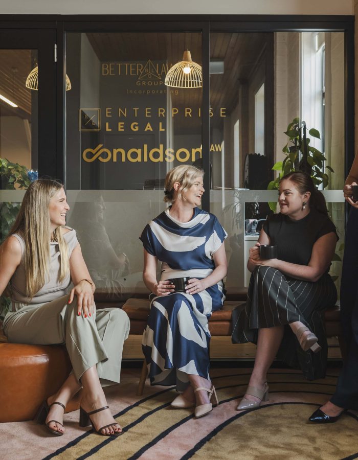 Women colleagues having a casual discussion in an office lounge, law firm in Toowoomba Queensland.