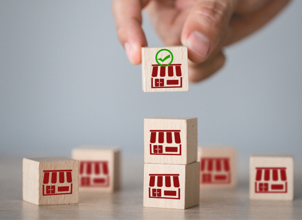 Small wooden blocks with shopfront icons, representing property and business law.