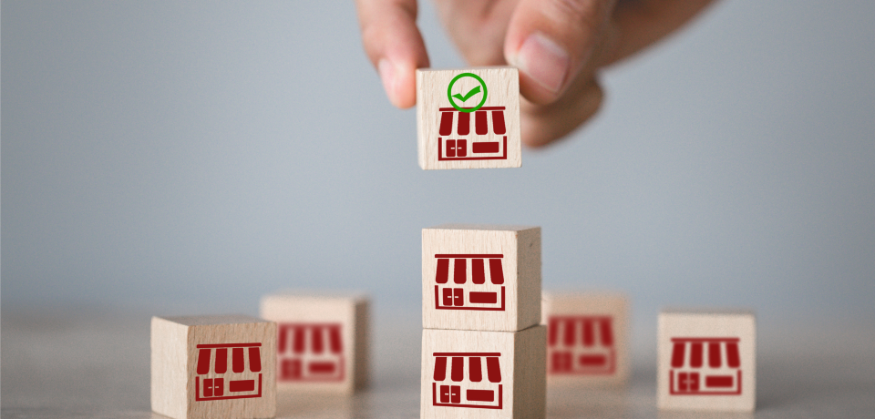 Small wooden blocks with shopfront icons, representing property and business law.