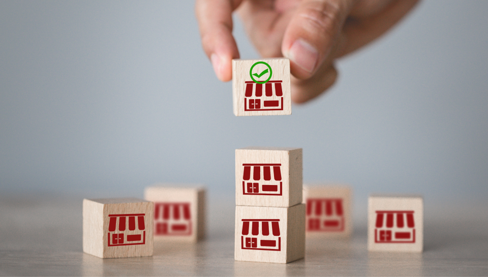 Small wooden blocks with shopfront icons, representing property and business law.