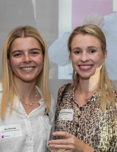 Professional women smiling at legal seminar in Toowoomba, Queensland.