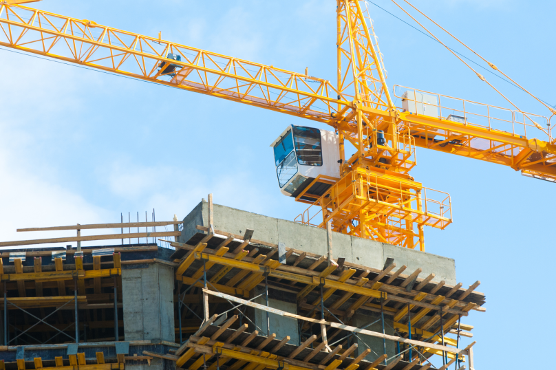 Construction site with tower crane and concrete building framework in Toowoomba, Queensland.