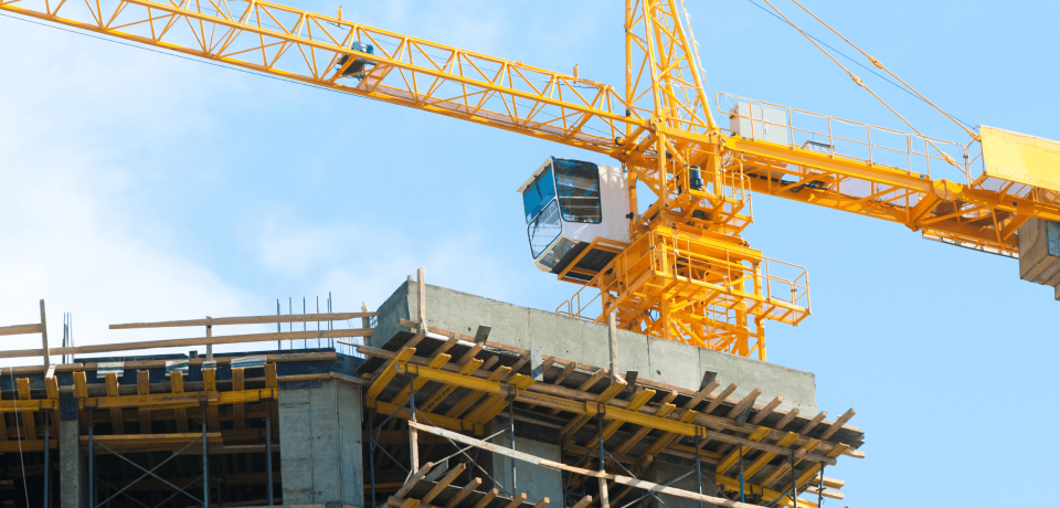 Construction site with tower crane and concrete building framework in Toowoomba, Queensland.