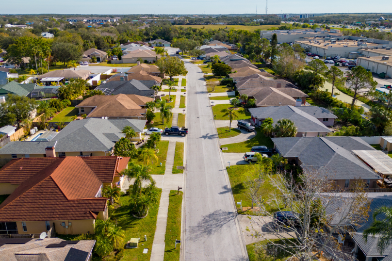 Suburban residential street in Toowoomba, Queensland with family homes and lush gardens.