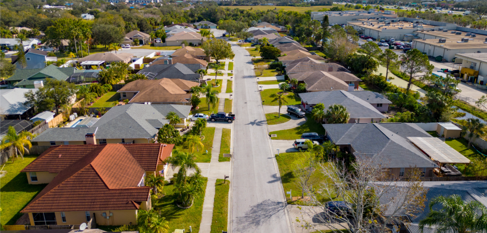 Suburban residential street in Toowoomba, Queensland with family homes and lush gardens.