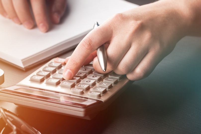 Calculator and legal notes representing property, business, and construction law services in Toowoomba, Queensland.