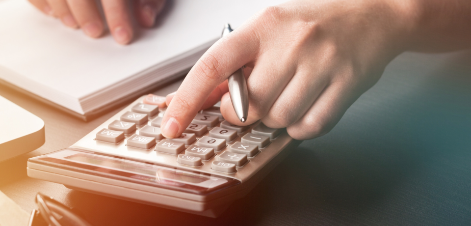 Calculator and legal notes representing property, business, and construction law services in Toowoomba, Queensland.