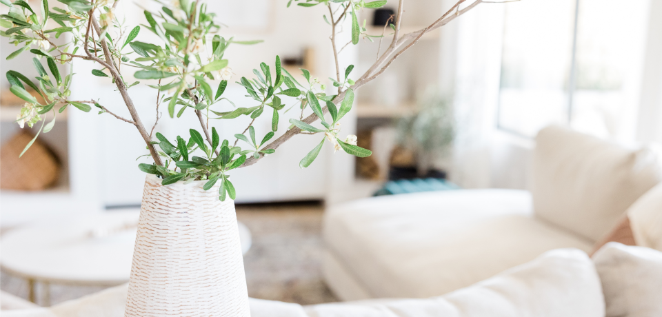 Elegant living room with natural light and greenery, highlighting interior design.