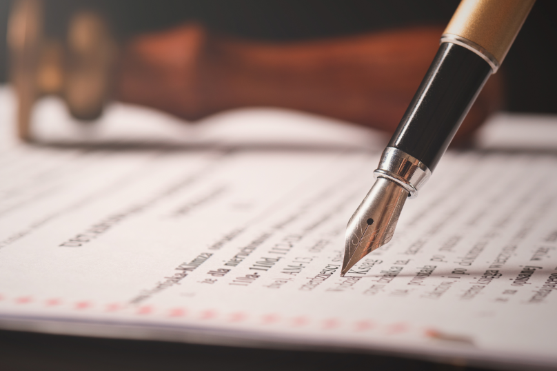 Close-up of a fountain pen on legal document, law firm in Toowoomba Queensland, property and civil dispute legal services.